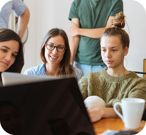 S4L Partners diverse team collaborating intently on a project displayed on a laptop screen.