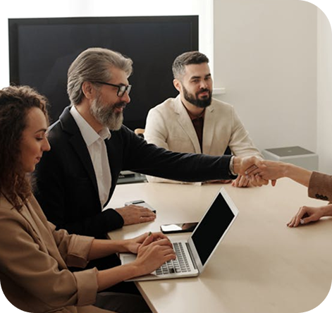 S4L Partners leadership team welcoming a new client with a handshake.